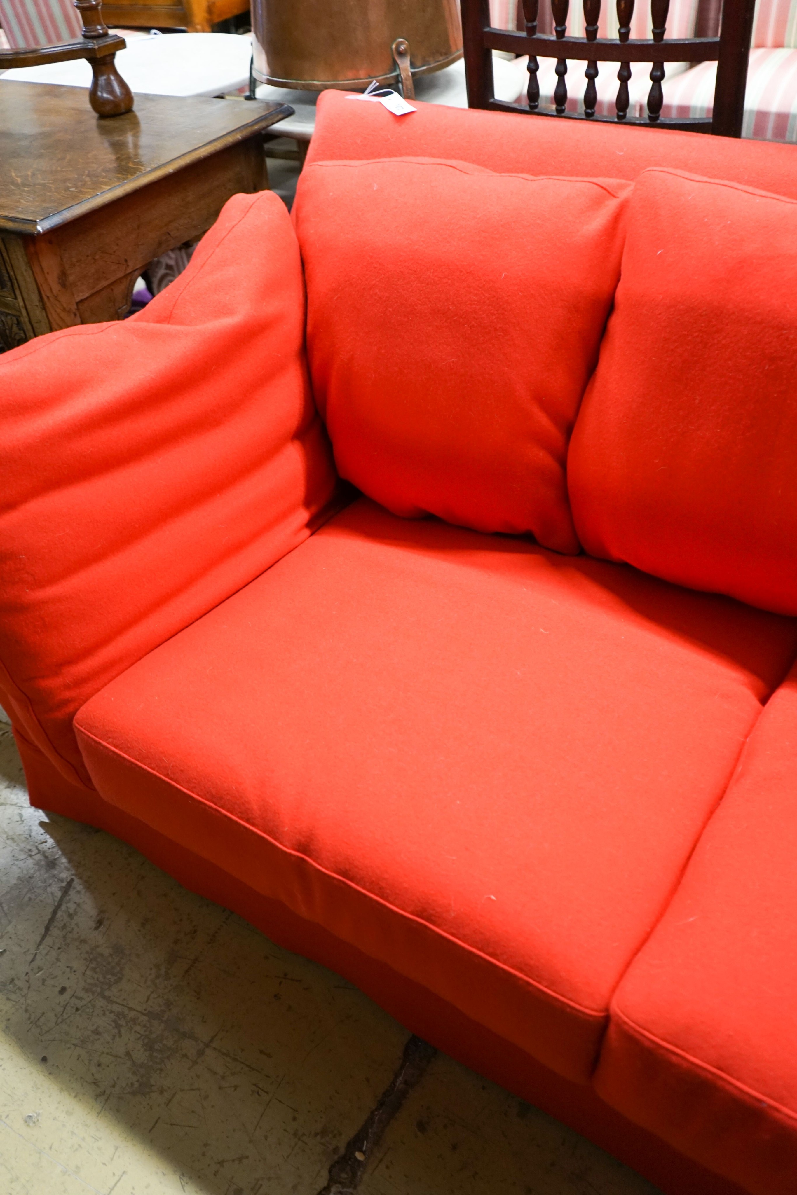 A contemporary Moroso three seater and two seater sofa upholstered in red fabric, the larger length 250cm, depth 100cm, height 79cm
